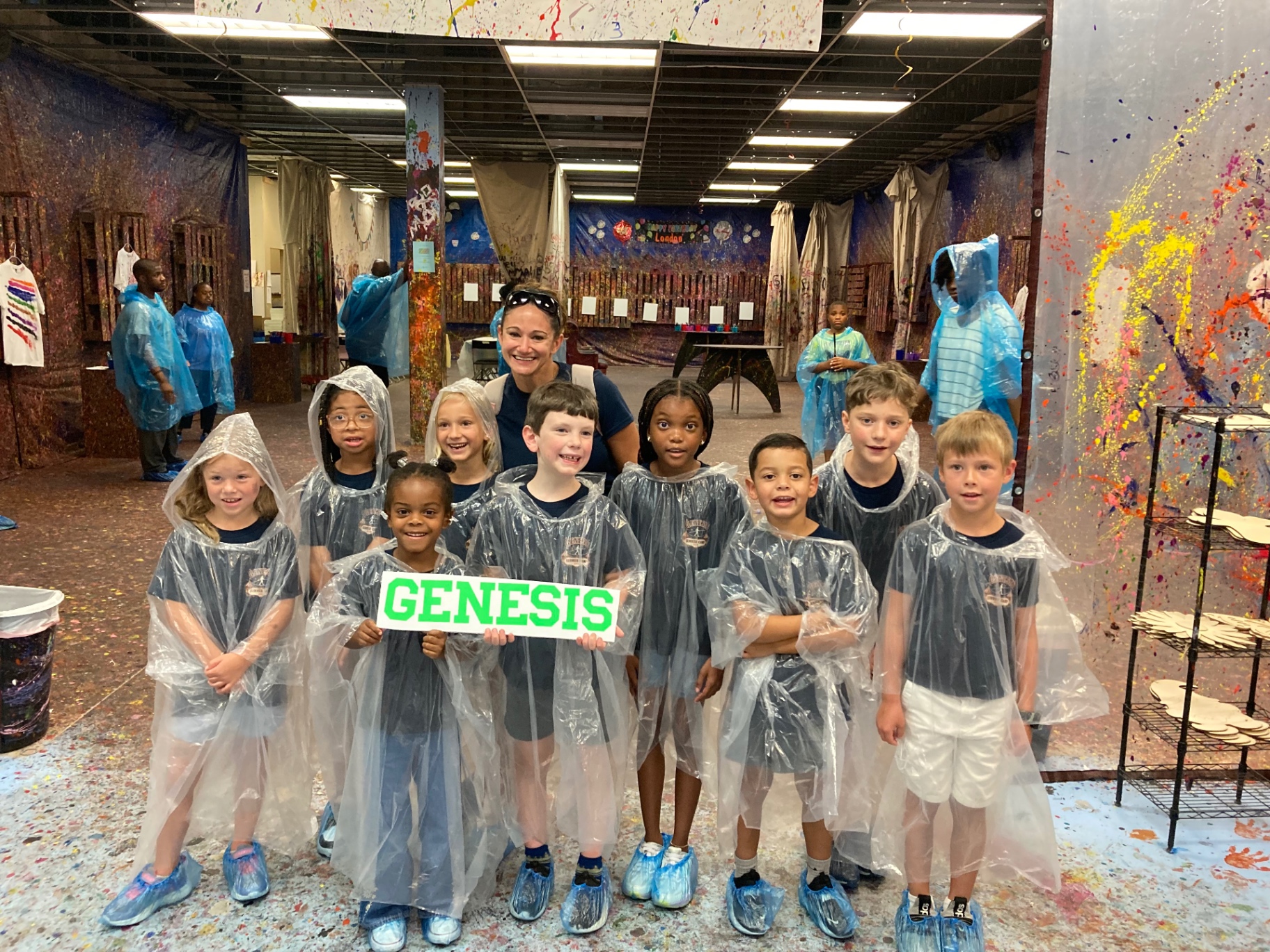 A school group in ponchos ready to paint